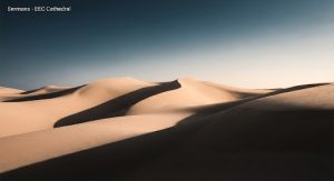 An abstract, stylized shot of rolling desert dunes under a dramatic, high-contrast sky. The sand has a soft, golden hue, while deep shadows create strong geometric shapes. The image feels vast, minimalist, and slightly ethereal, evoking themes of journey and wilderness. Contemporary editorial style.